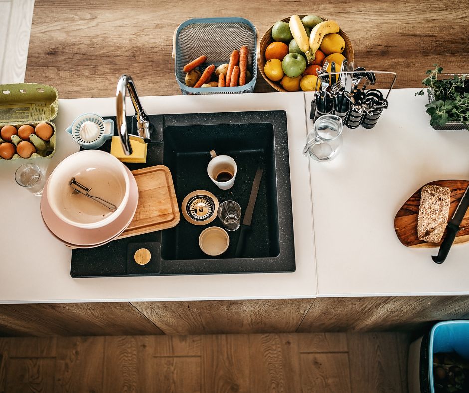 kitchen counter with dirty dishes in sink