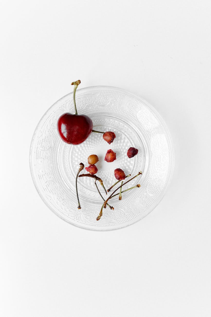 eaten red cherries on a plate