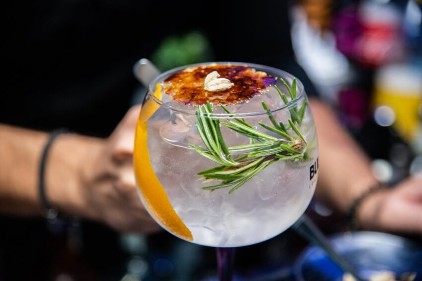 close up photo of cocktail with herb