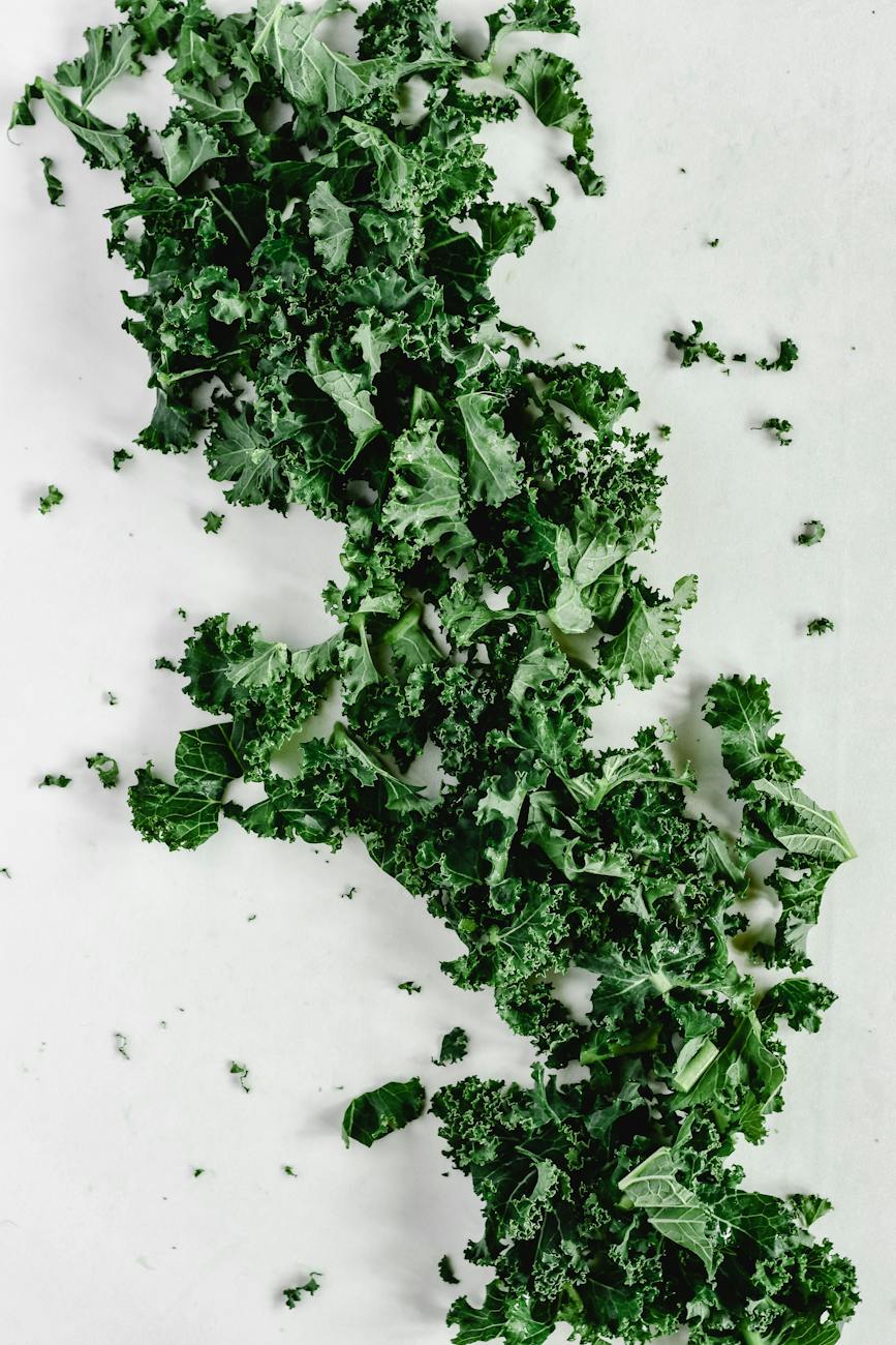 close up shot of chopped kale on a white surface