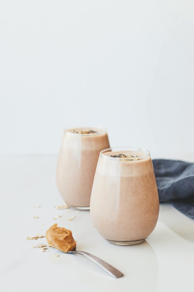 Delicious peanut butter chocolate smoothies with oats in glass tumblers.