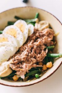 Delicious salad featuring tuna, boiled eggs, green beans, and chickpeas for a nutritious meal.