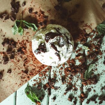 Top view of mint chocolate ice cream with cocoa and mint leaves.